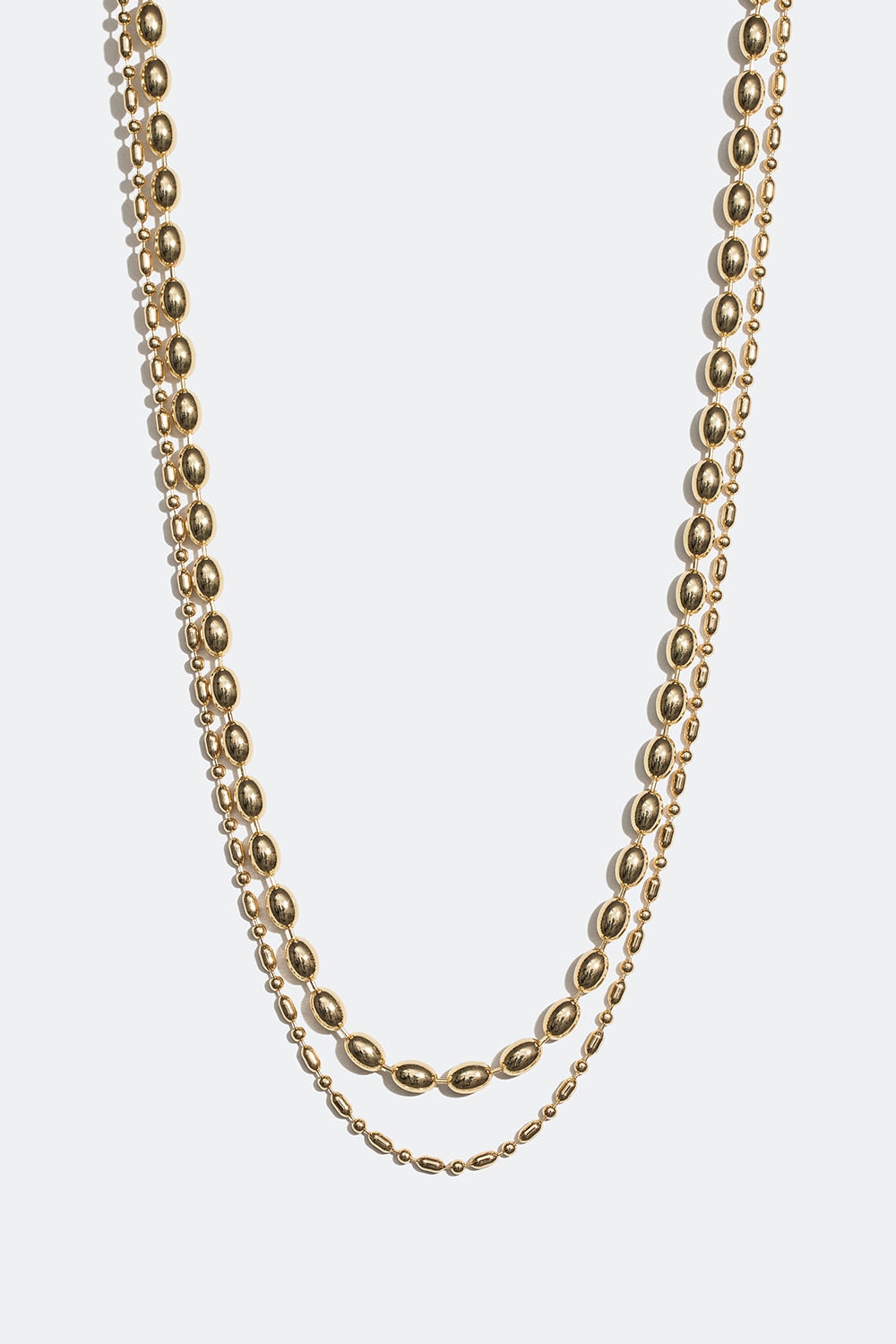 Guldfarvet dobbelt halskæde med ovale perler i metal i gruppen Smykker / Halskæder / Halskæder med vedhæng hos Glitter (254001312002)