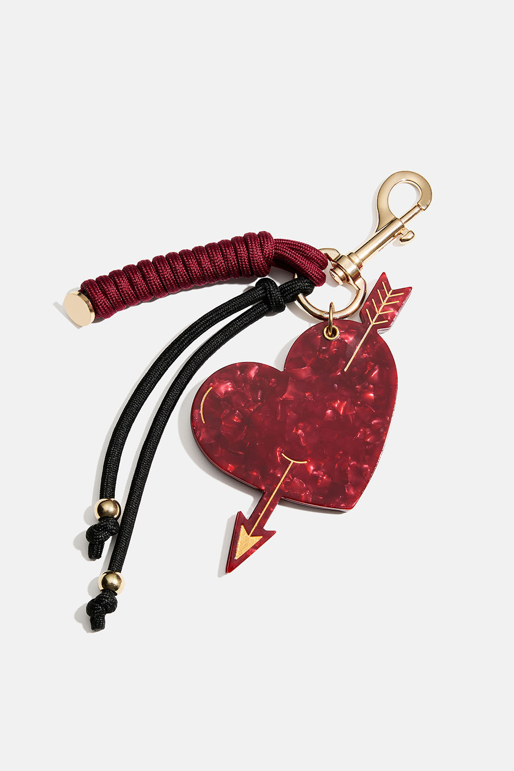 Taskepynt med lille spejl, hjerte og snor.