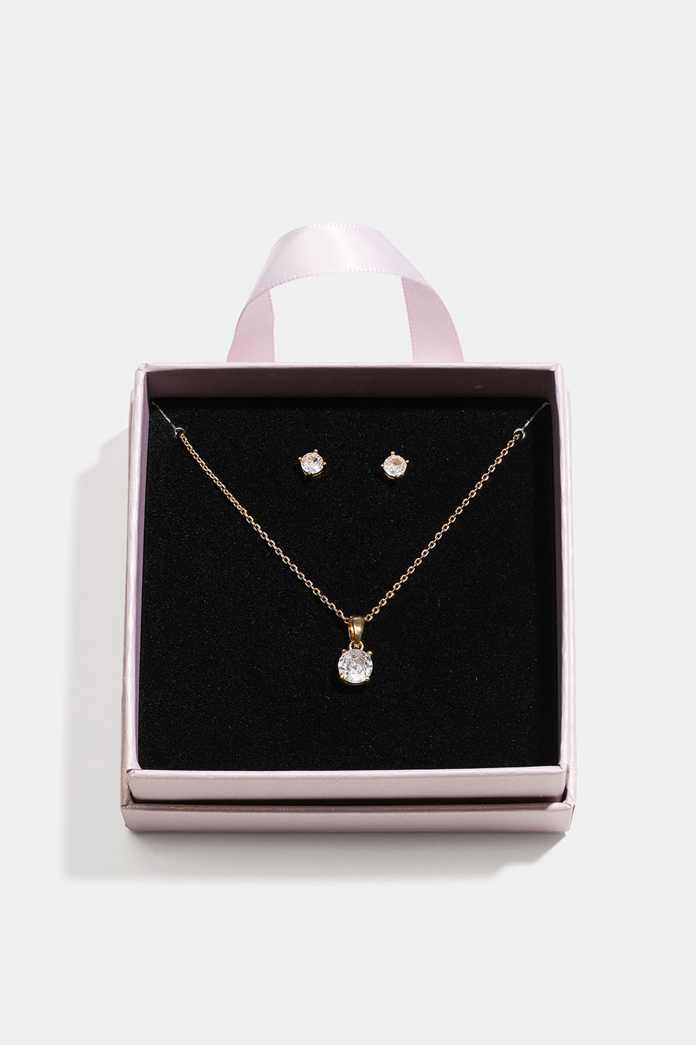 Guldfarvet smykkesæt med glassten i gaveæske