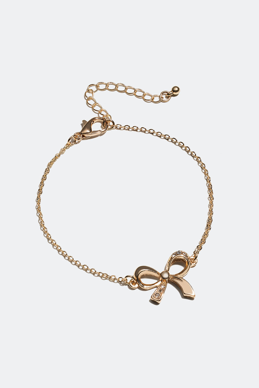 Guldfarvet armbånd med sløjfe og glassten