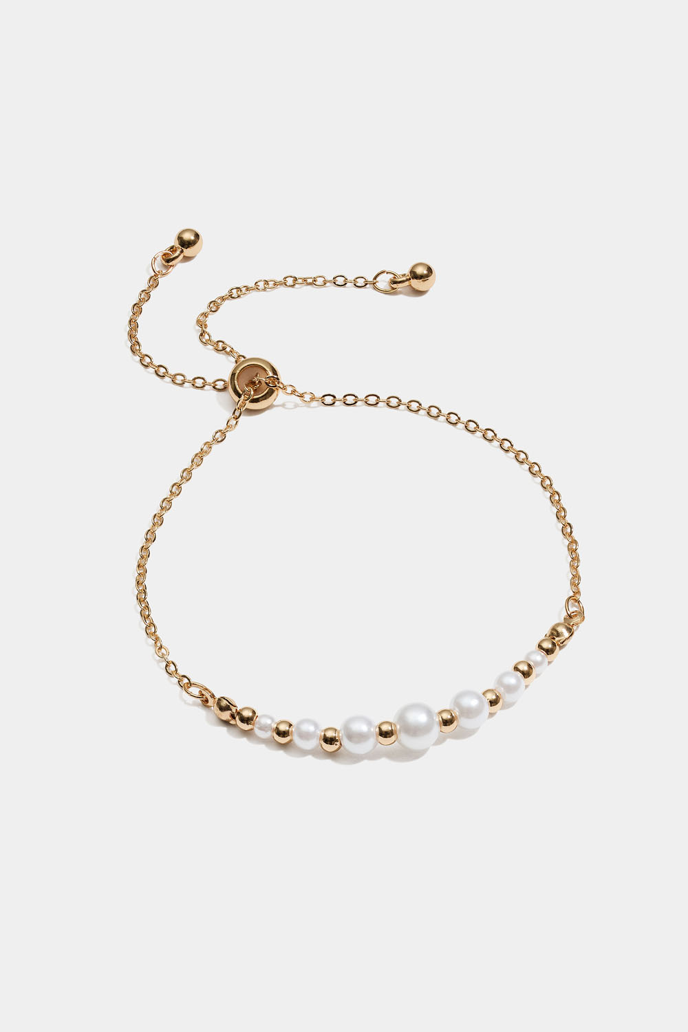 Armbånd med hvide og guldfarvede perler
