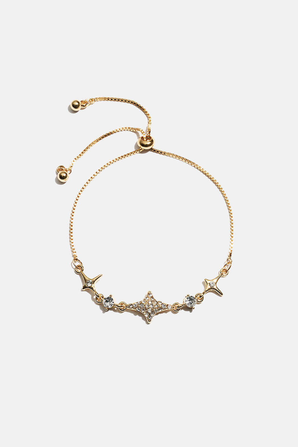 Guldfarvet armbånd med stjerner og rhinsten
