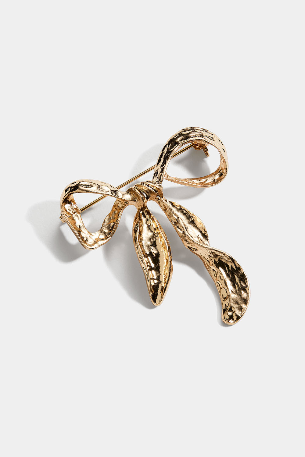 Guldfarvet broche med hamret sløjfe