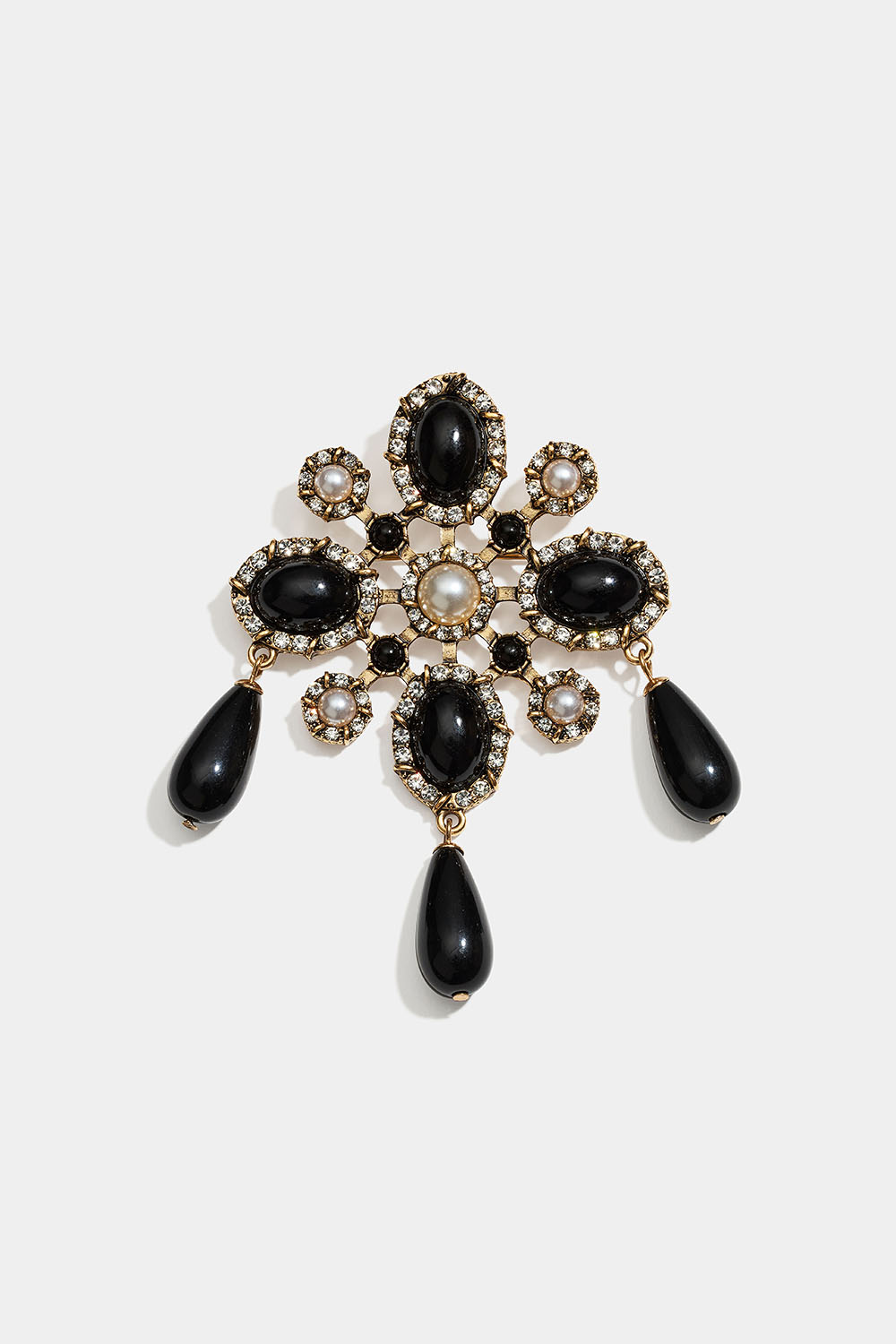 Guldfarvet broche med sorte og hvide perler og glassten