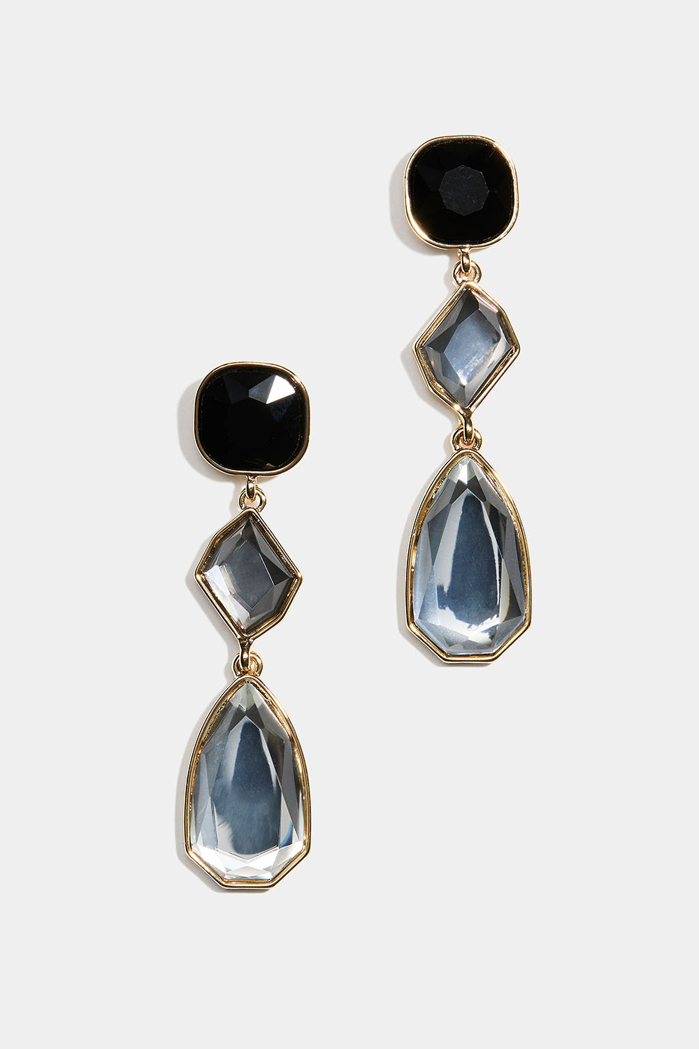 Lange øreringe med sorte og hvide sten i forskellige former