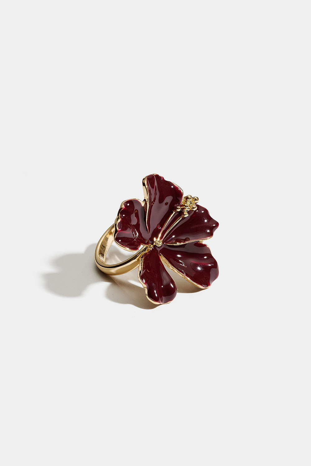 Guldfarvet ring med en bordeauxfarvet blomst