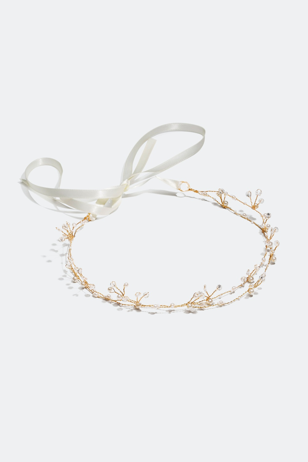 Guldfarvet hårdekoration med sten og perler