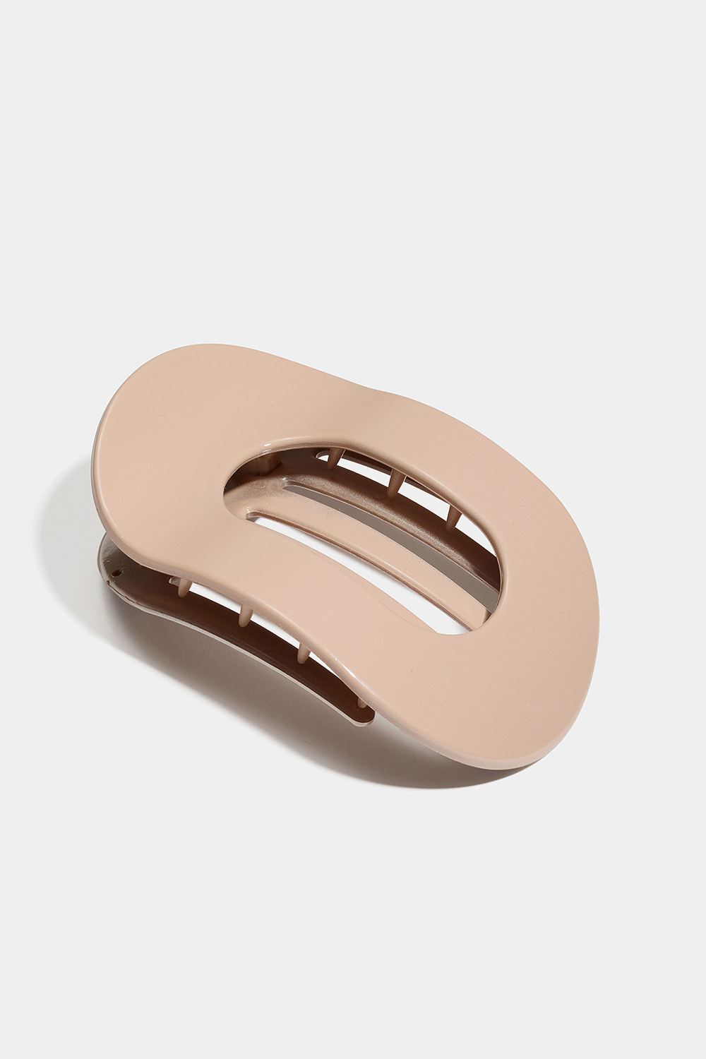 Beige, ovalt, fladt hårspænde