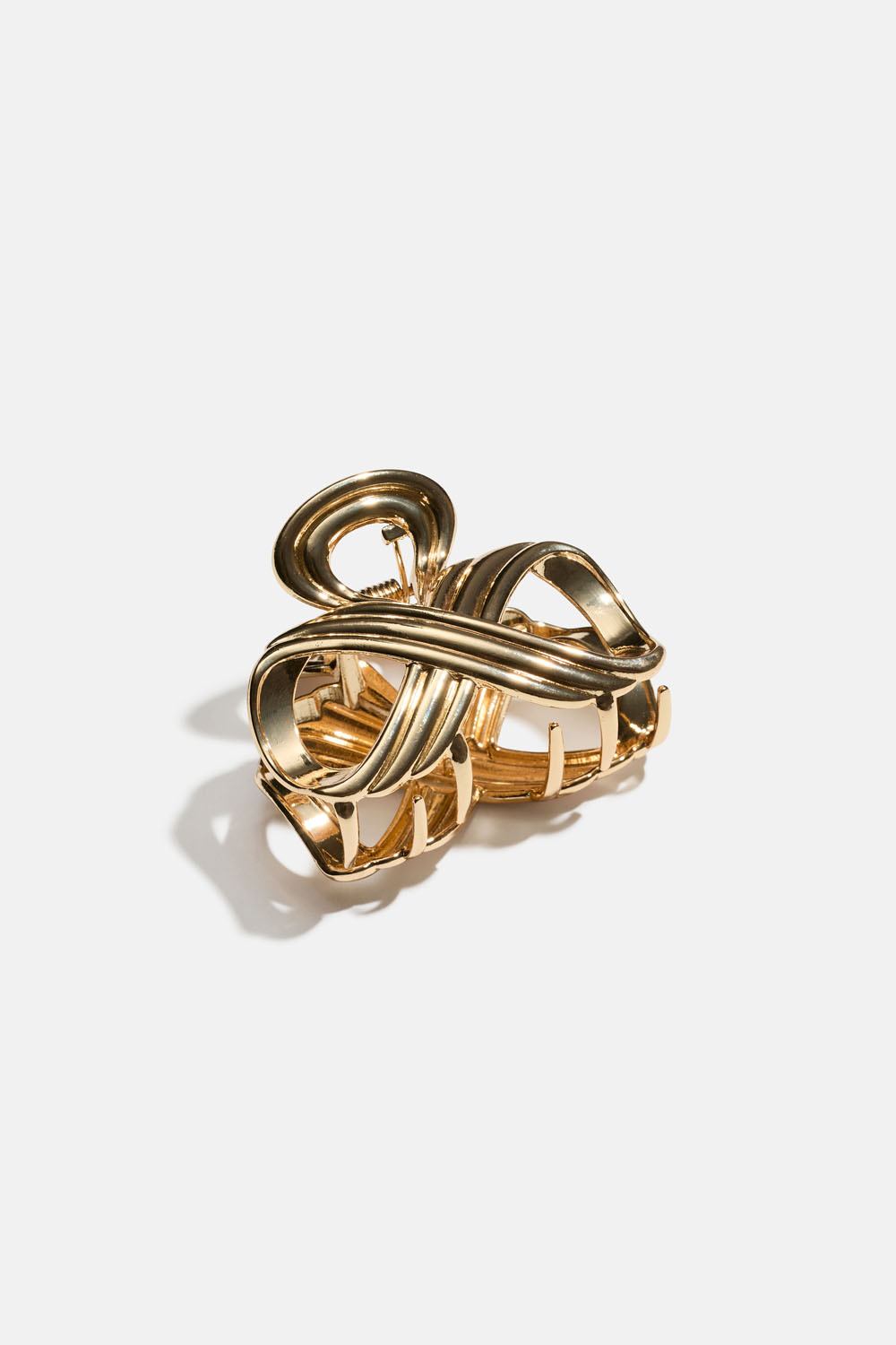 Guldfarvet hårspænde i metal med runde former