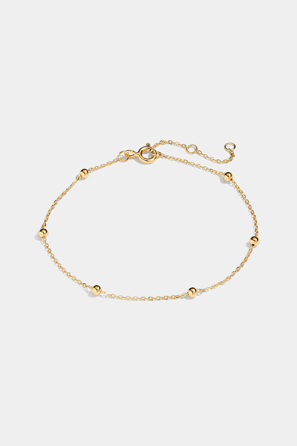 Tyndt armbånd med små kugler i 18 karat forgyldt sølv.