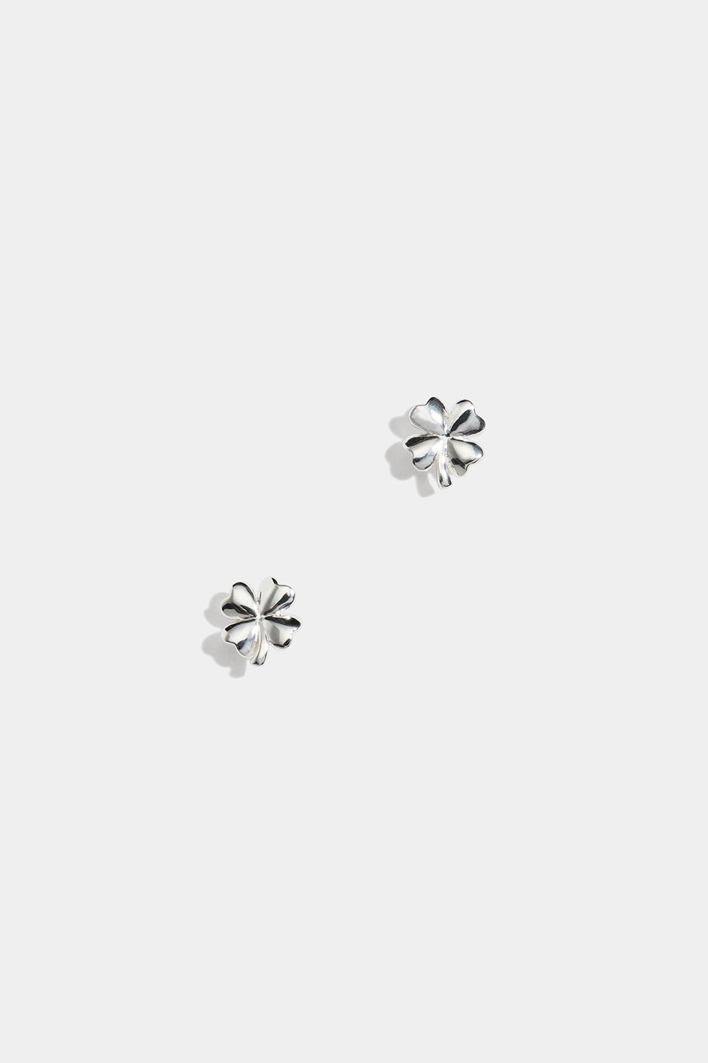 Små sølvørestikker i form af et firkløver